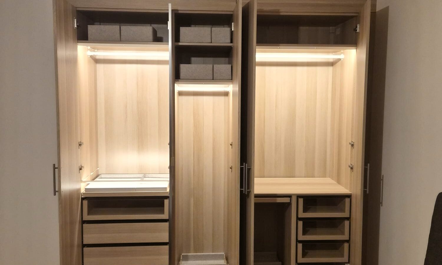 Intérieur de dressing éclairé, tiroirs et penderies, réalisation Mobel Design à Genève